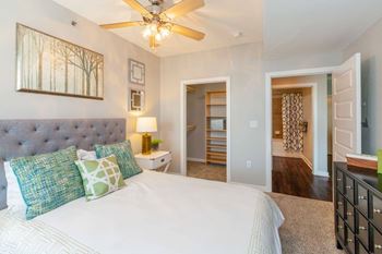 A bedroom with a large bed and a ceiling fan at 45 Madison Apartments, Kansas City, 64111